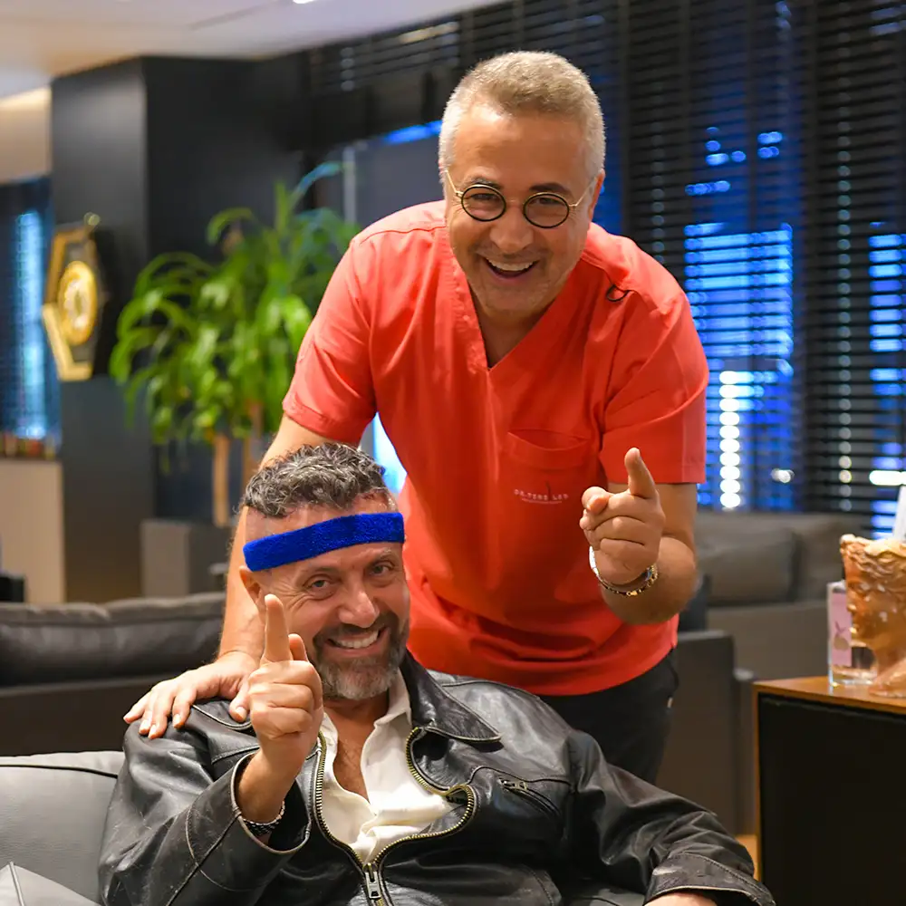Dr. Servet Terziler with a patient after a hair transplant package consultation in Istanbul