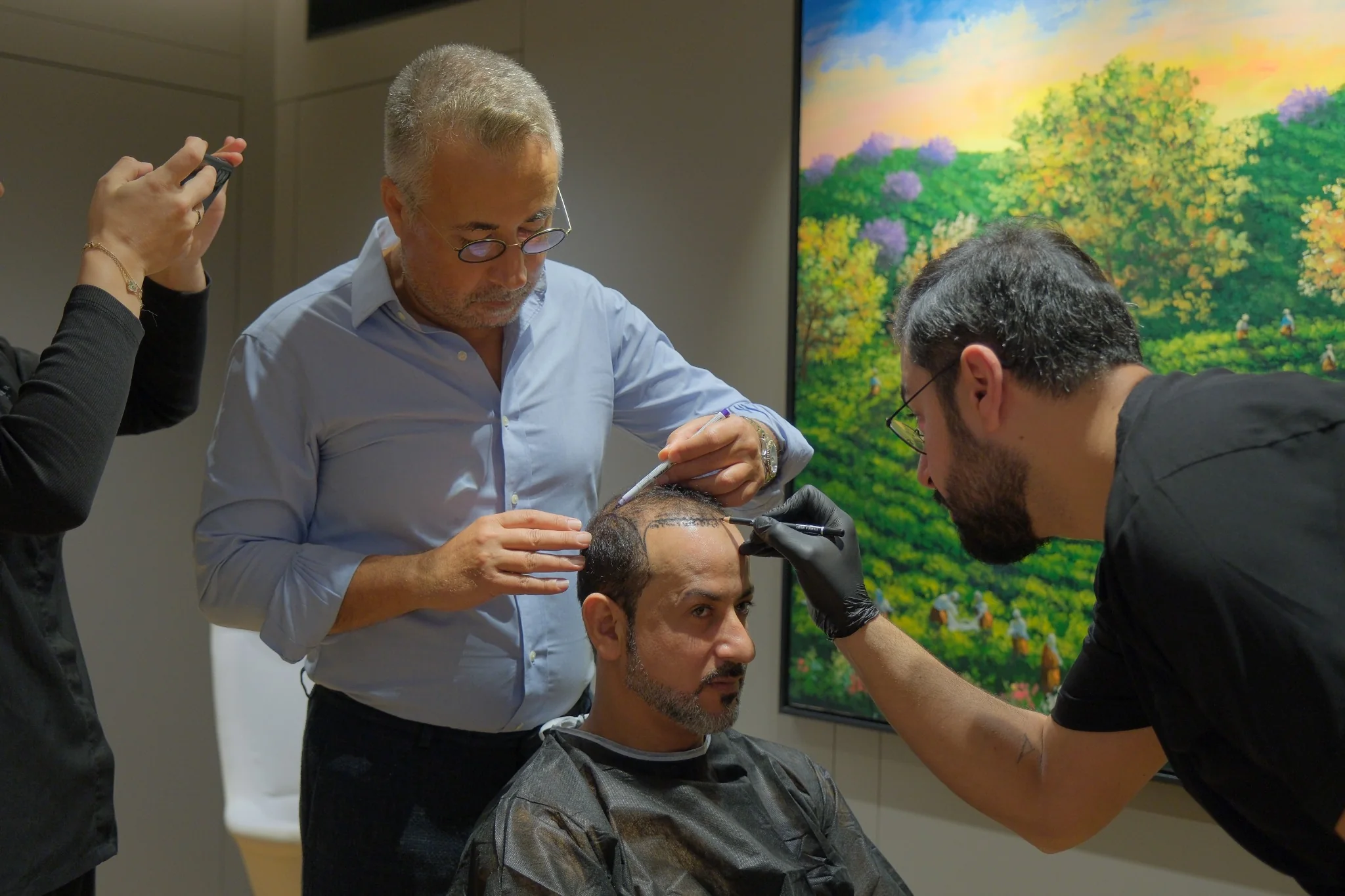 Dr. Servet Terziler and clinical team designing a patient’s hairline before hair transplant surgery at Dr. Terziler Exclusive Clinic in Istanbul